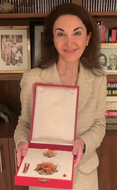Dr. Iliana Sweis holding a box with the honorary medal she received