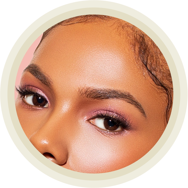 Beautiful Black Woman posing in studio on peach background.